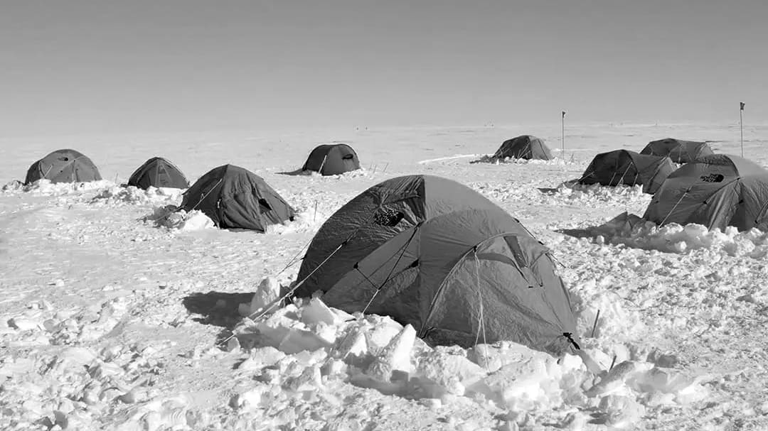 Tents on snowy Antarctic landscape