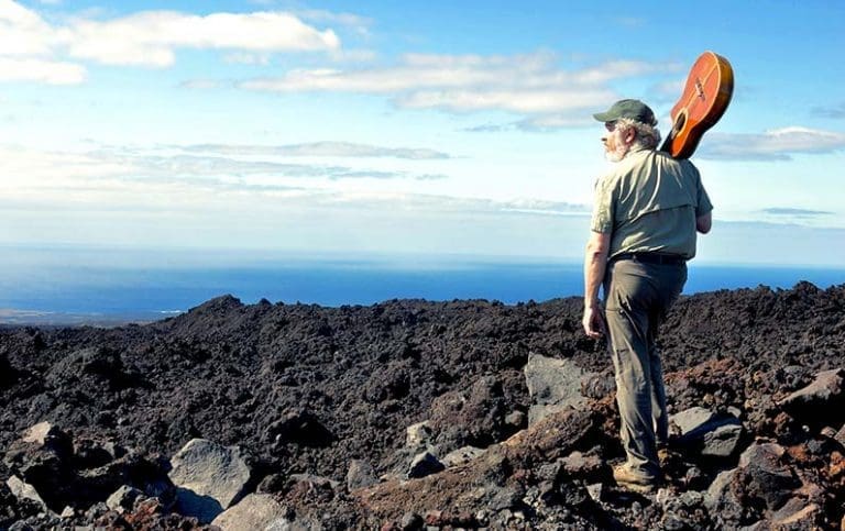Glenn in Hawaii with guitar looking left